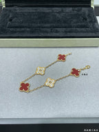 Gold-tone clover bracelet with red enamel and pavé quatrefoil charms