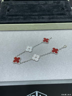 Silver-tone clover bracelet with red enamel and pavé quatrefoil charms