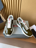 Prada unisex sneakers on box, olive green patent leather with white laces