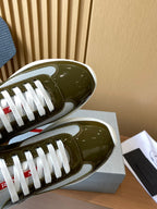 Prada unisex sneaker toe view, olive green patent leather with white laces