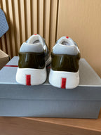 Prada unisex sneakers, rear view with white heel tabs and red stripe accents