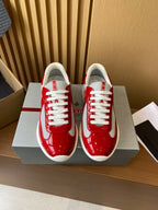 Prada unisex sneakers in red patent with white laces and white trim, on box