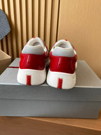 Prada unisex sneakers with red heel and white block sole, rear view