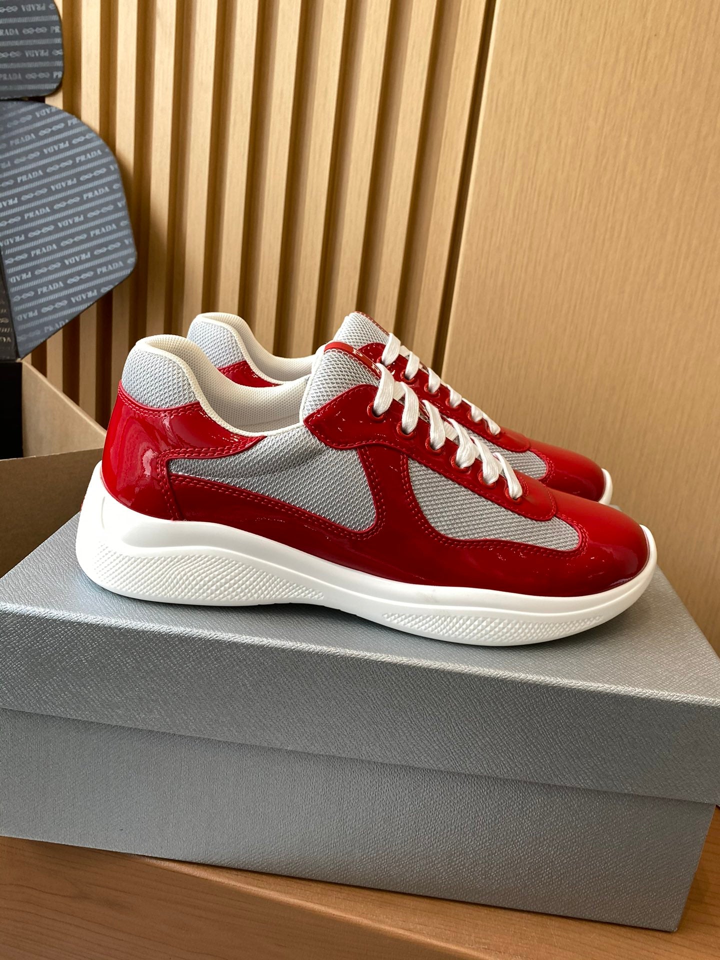 Prada unisex sneakers, red and white with chunky white sole and lace-up front