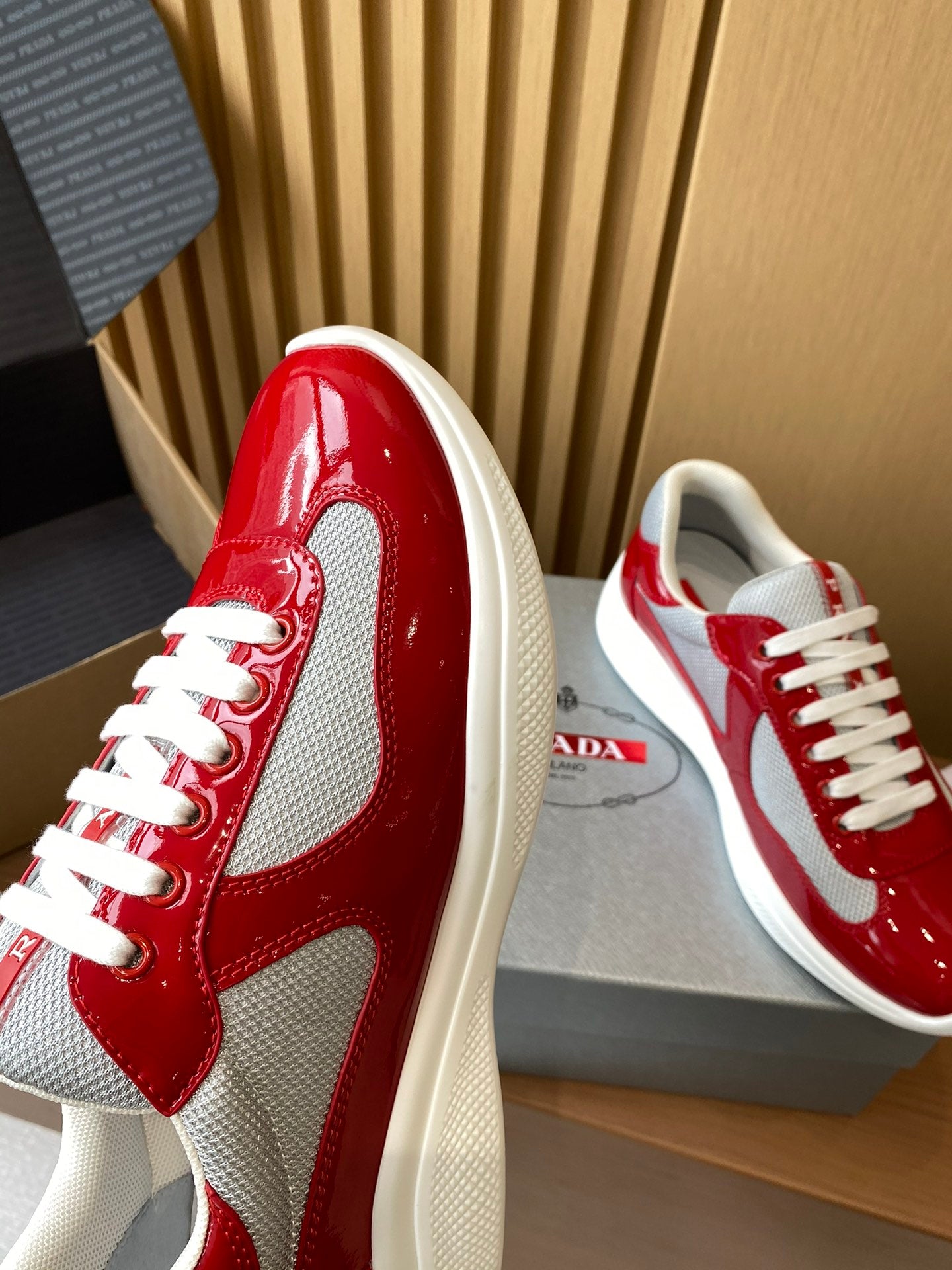 Prada unisex sneakers red glossy leather with white mesh side panel and lace-up