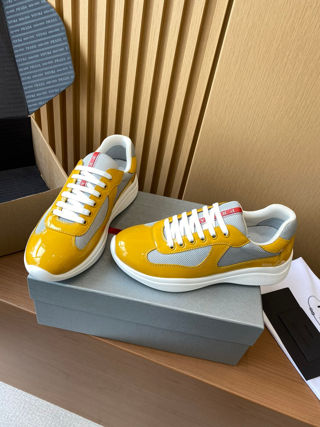 Prada unisex sneakers, yellow and gray with white laces and red heel label