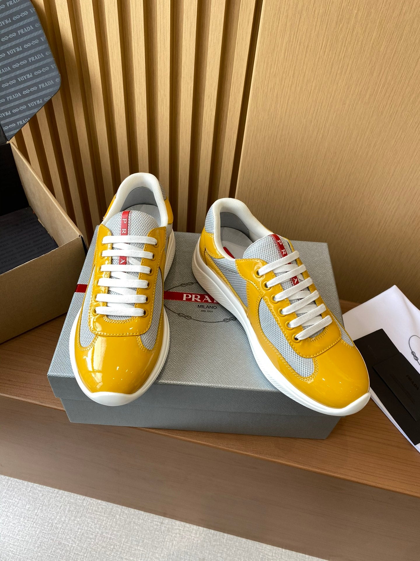 Prada unisex low-top sneakers, yellow and gray panels with white laces and trim