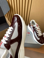 Burgundy and white low-top sneaker with mesh side panel and white laces, heel detail