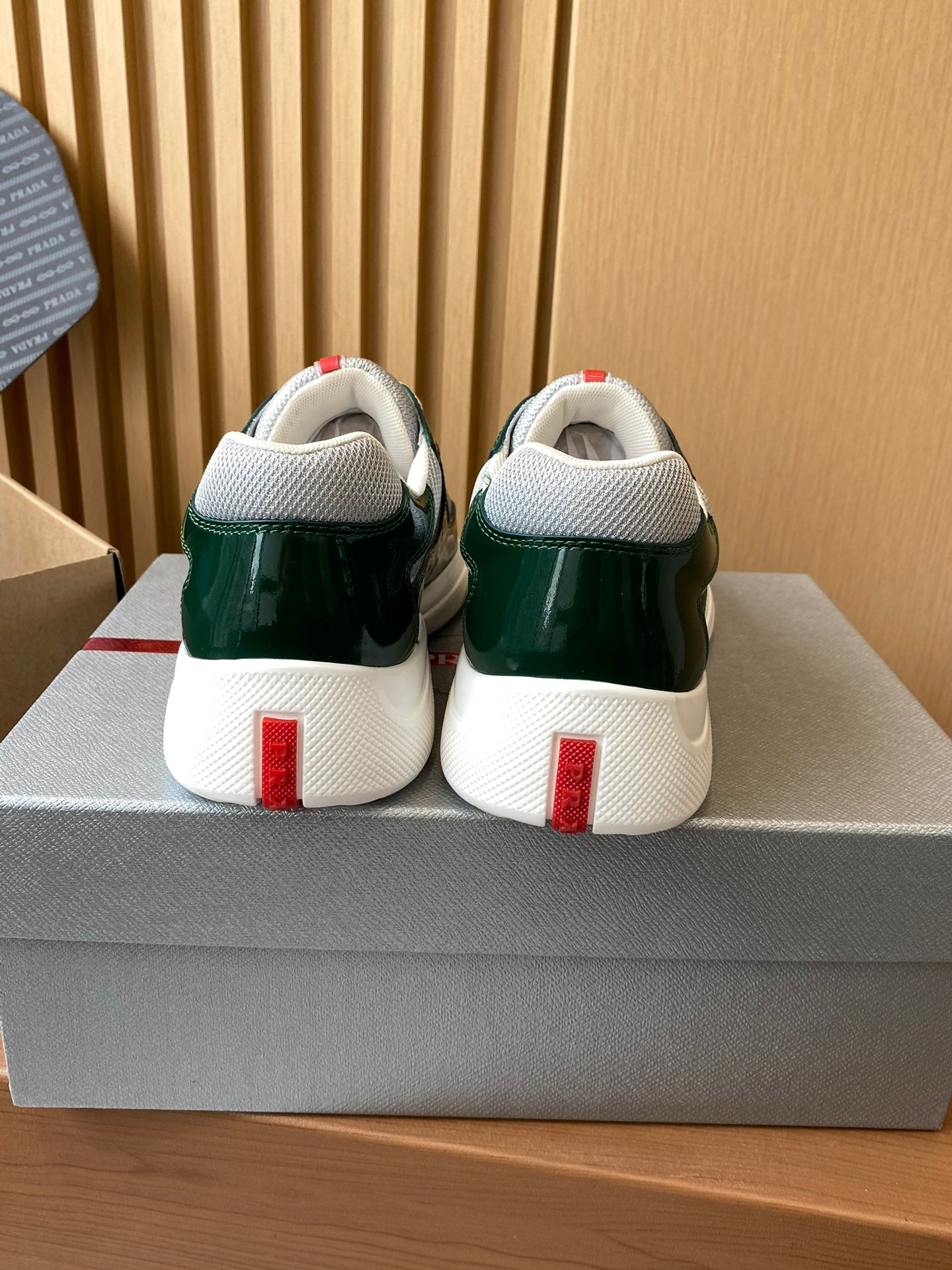 Prada unisex green sneakers, back view with white heel tabs and sole