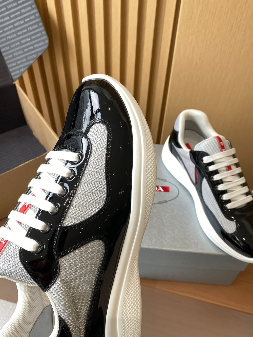 Prada unisex sneaker toe and side, black patent and grey mesh with white laces