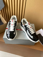 Prada unisex low-top sneakers, black patent leather with grey swoosh, white laces