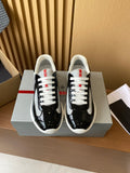 Prada unisex low-top sneakers, black patent with grey swoosh and white laces