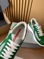 Prada unisex sneakers showing gray lining and red logo label at tongue