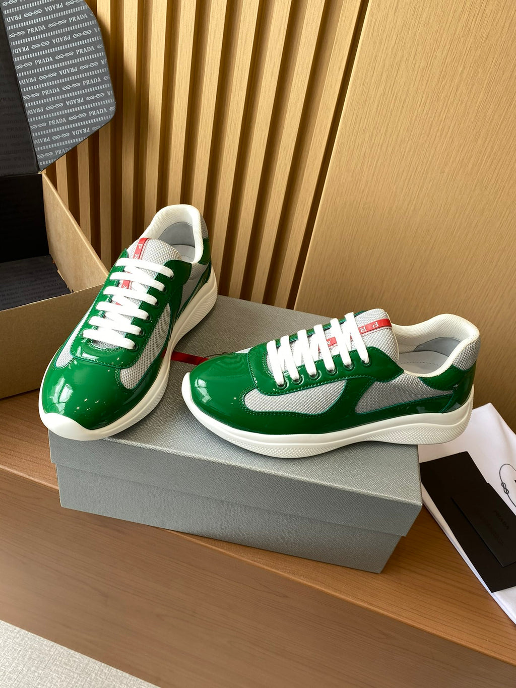 Prada unisex green patent sneakers with white laces, white midsole, red heel detail