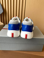 Prada unisex sneakers heel view, blue leather with white back and red tabs
