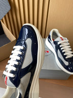 Prada navy and white sneaker toe and side view, textured panels with white laces