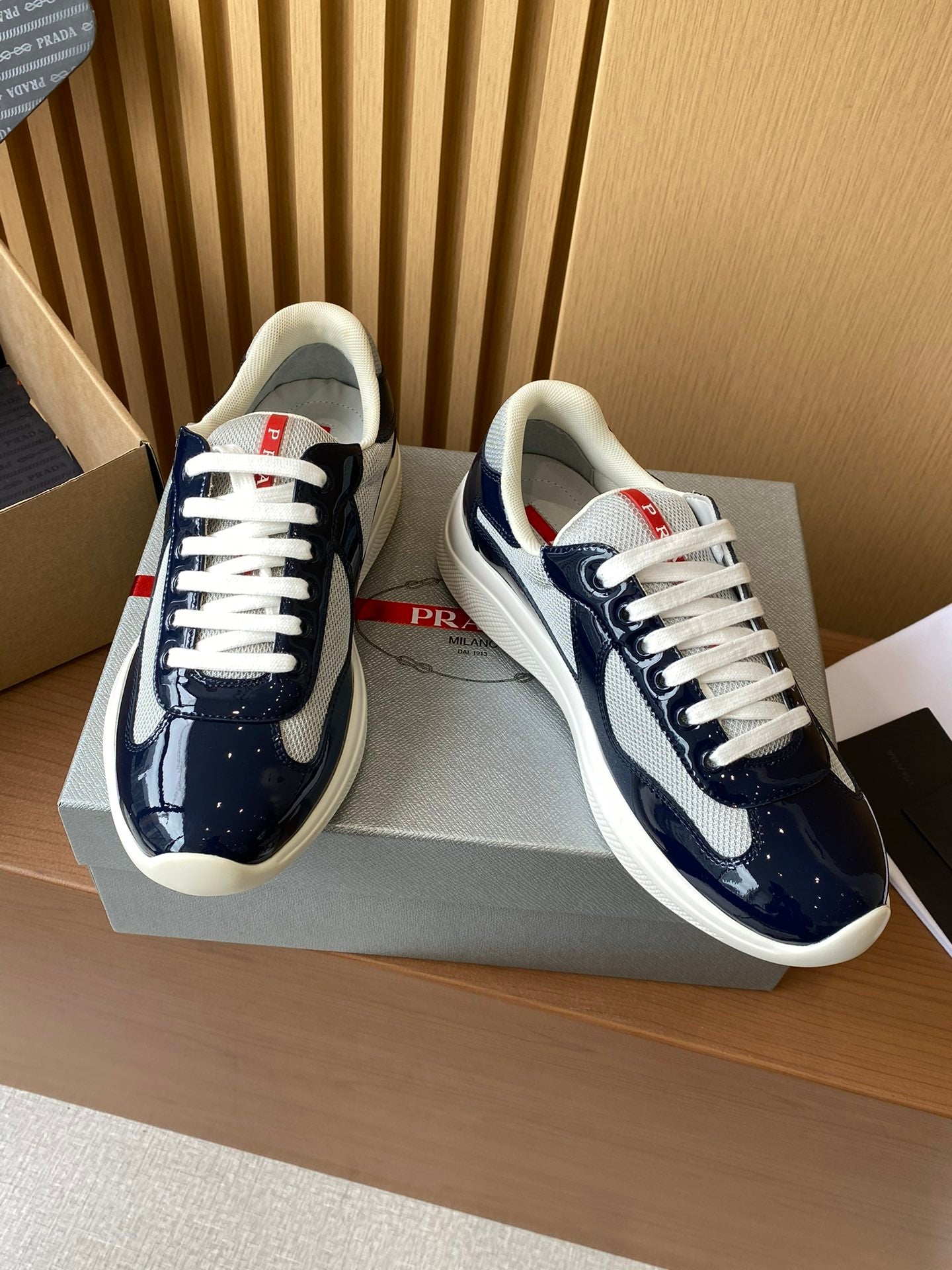 Prada lace-up low-top sneakers, navy patent and mesh panels with white laces