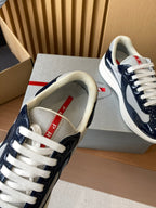 Prada lace-up low-top sneakers, close-up of white laces and navy-and-cream upper