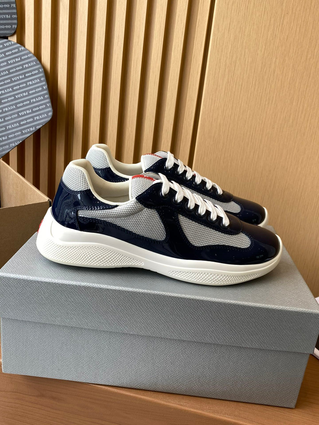 Prada navy and white lace-up low-top sneaker with textured panel and white sole