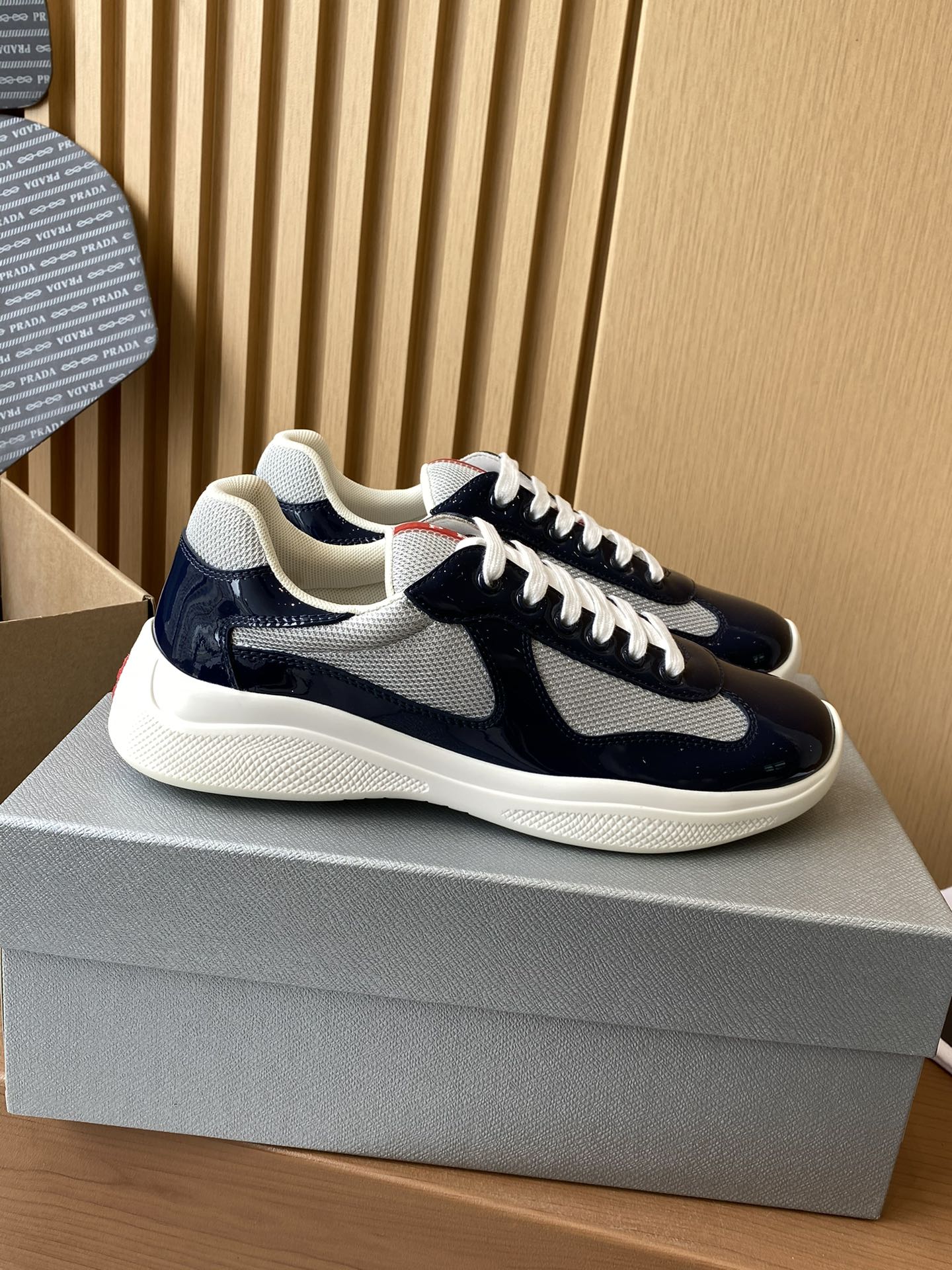 Prada navy and white lace-up low-top sneaker with textured panel and white sole
