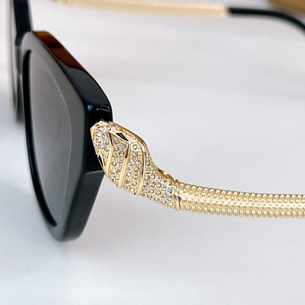 Bvlgari sunglasses temple detail with gold rhinestone chain on black frame