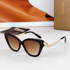 Bvlgari cat-eye sunglasses with dark frames, gold chain temple details, brown lenses