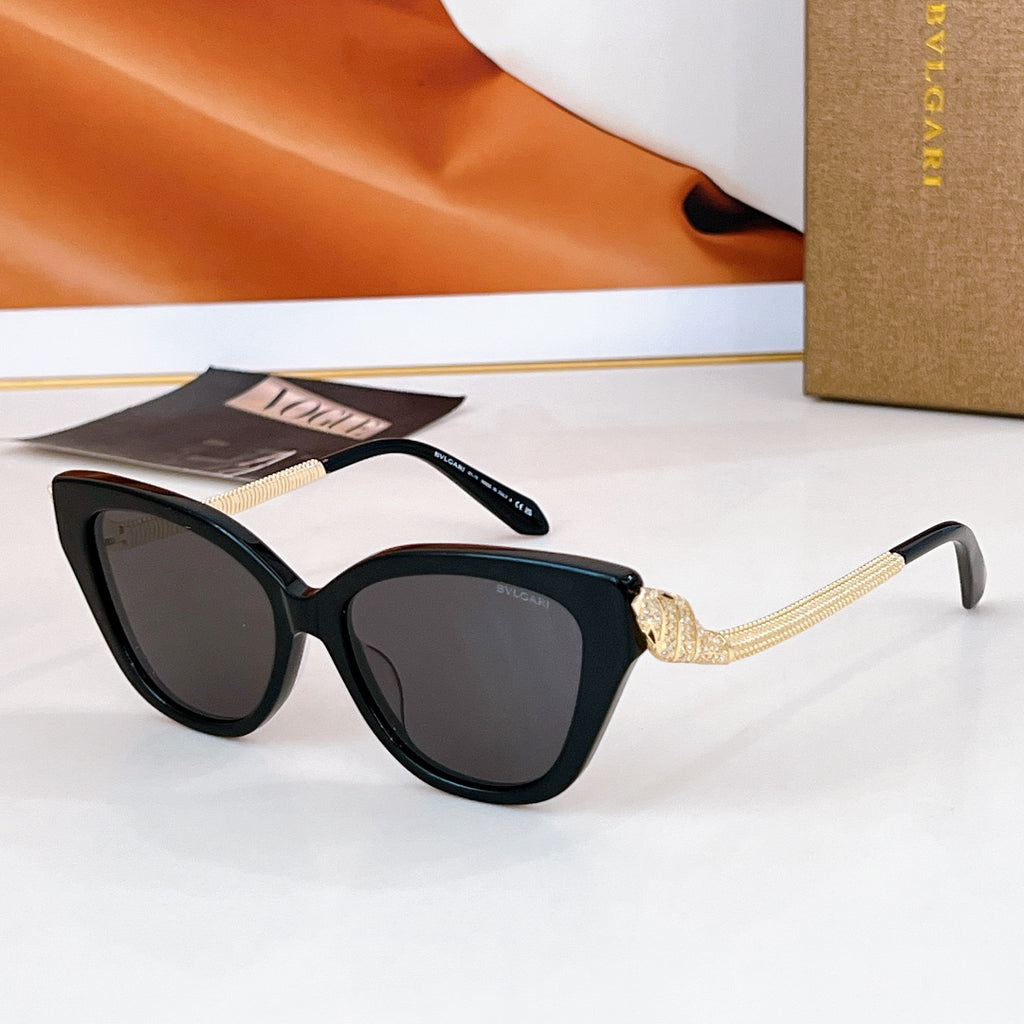 Bvlgari cat-eye sunglasses with dark frames, gold chain temple details, dark lenses