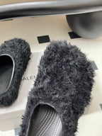 Black shaggy slide sandals with gray striped insole detail and rounded toe
