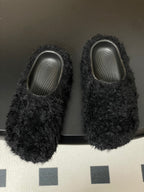 Pair of black shaggy slide sandals with textured gray insoles