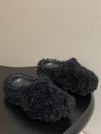 Black fuzzy slide sandals with gray rubber footbeds