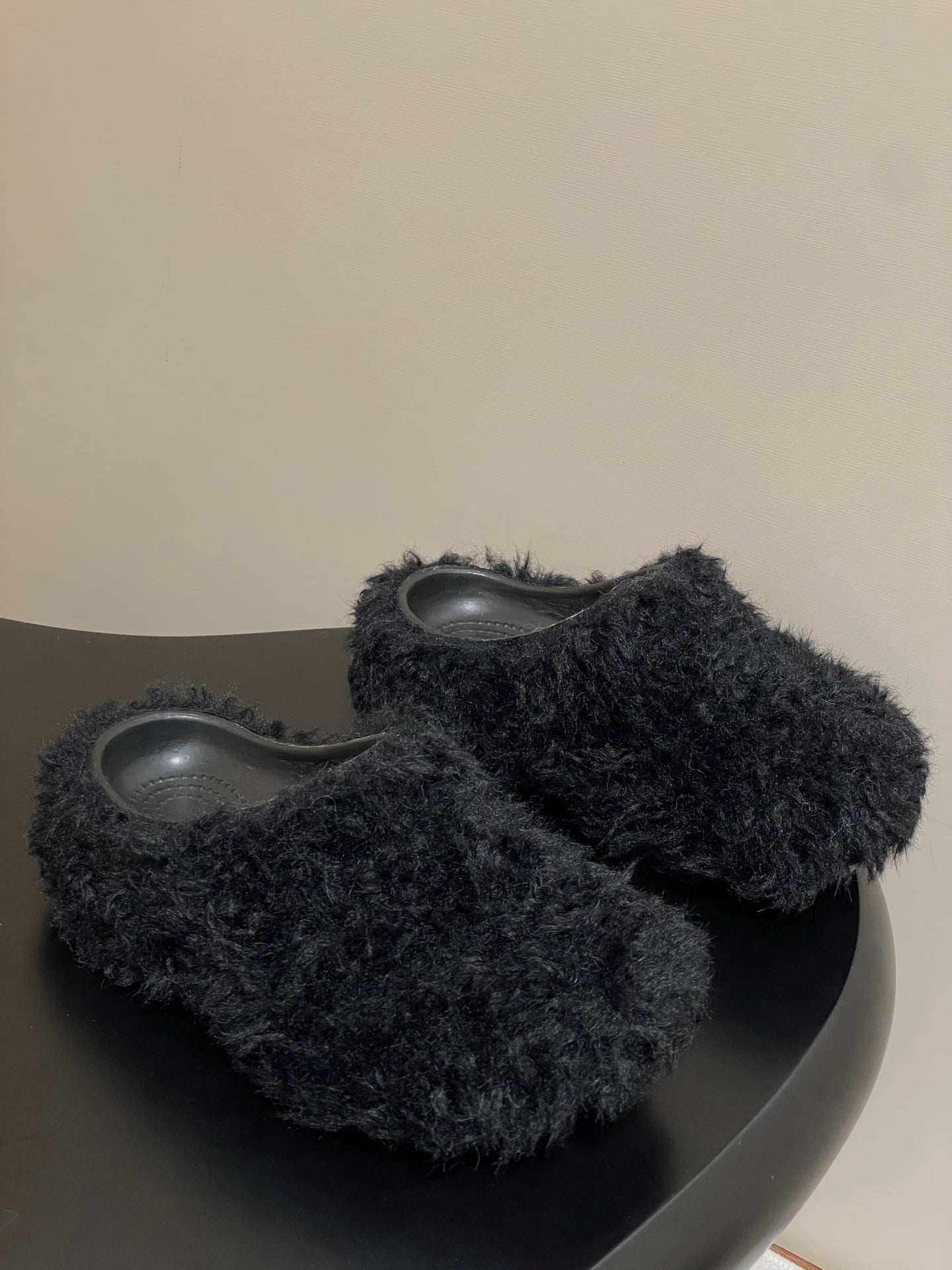 Black fuzzy slide sandals with gray rubber footbeds