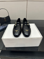Prada women's black leather loafers with gold-tone strap buckle and square toe