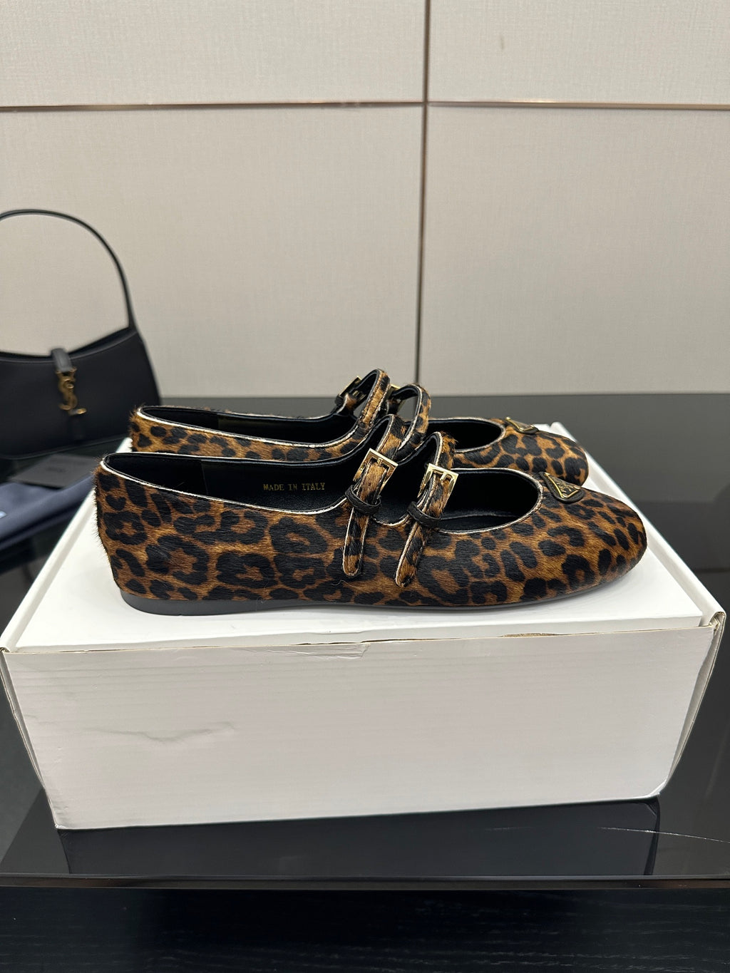 Prada leopard-print flat loafer pair with gold-tone buckle strap and black lining