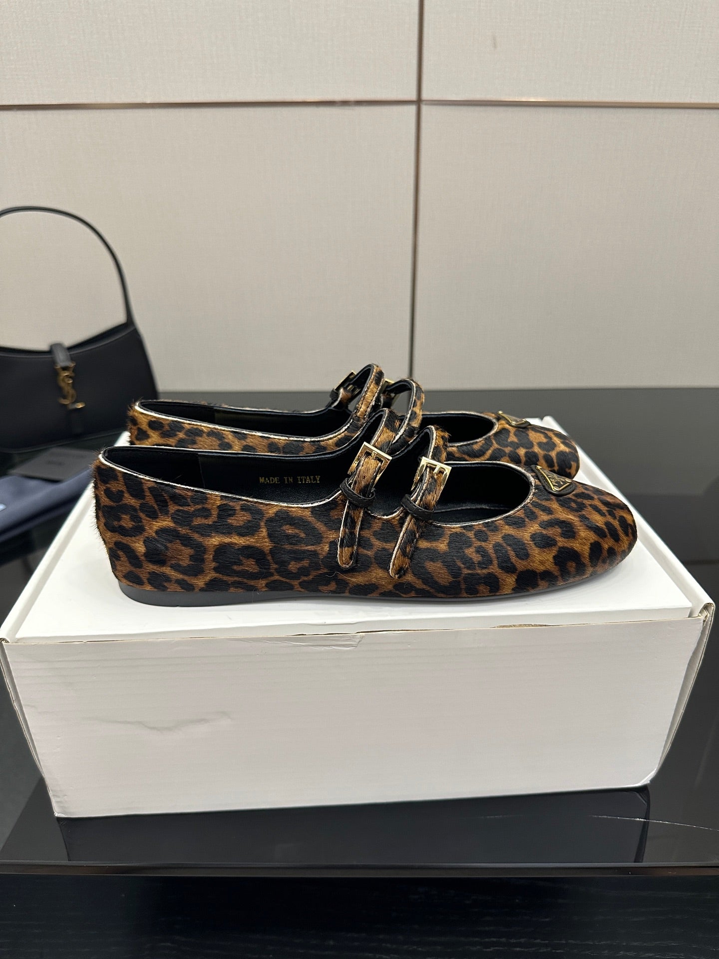 Prada leopard-print flat loafer pair with gold-tone buckle strap and black lining