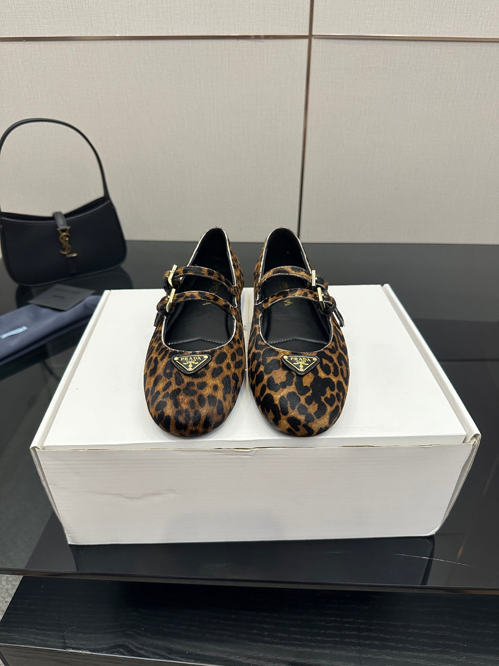 Prada ladies leopard-print flat loafers with black straps and gold-tone buckles