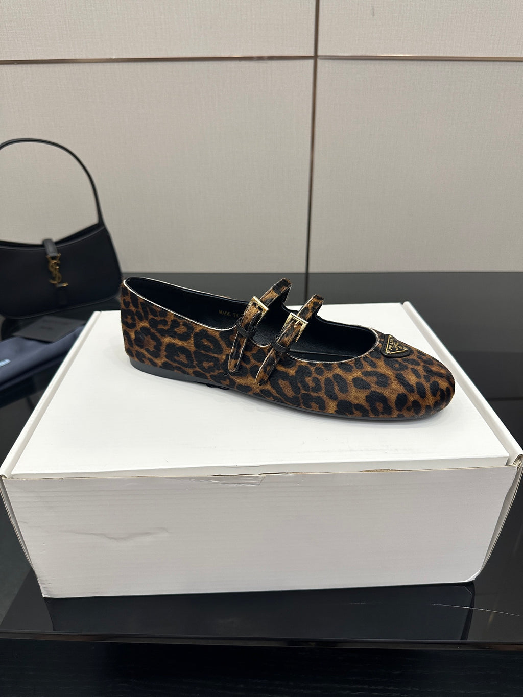 Prada leopard-print flat loafers with two straps and gold buckles, front view