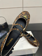 Prada leopard-print flat loafer close-up, black lining and gold buckle strap