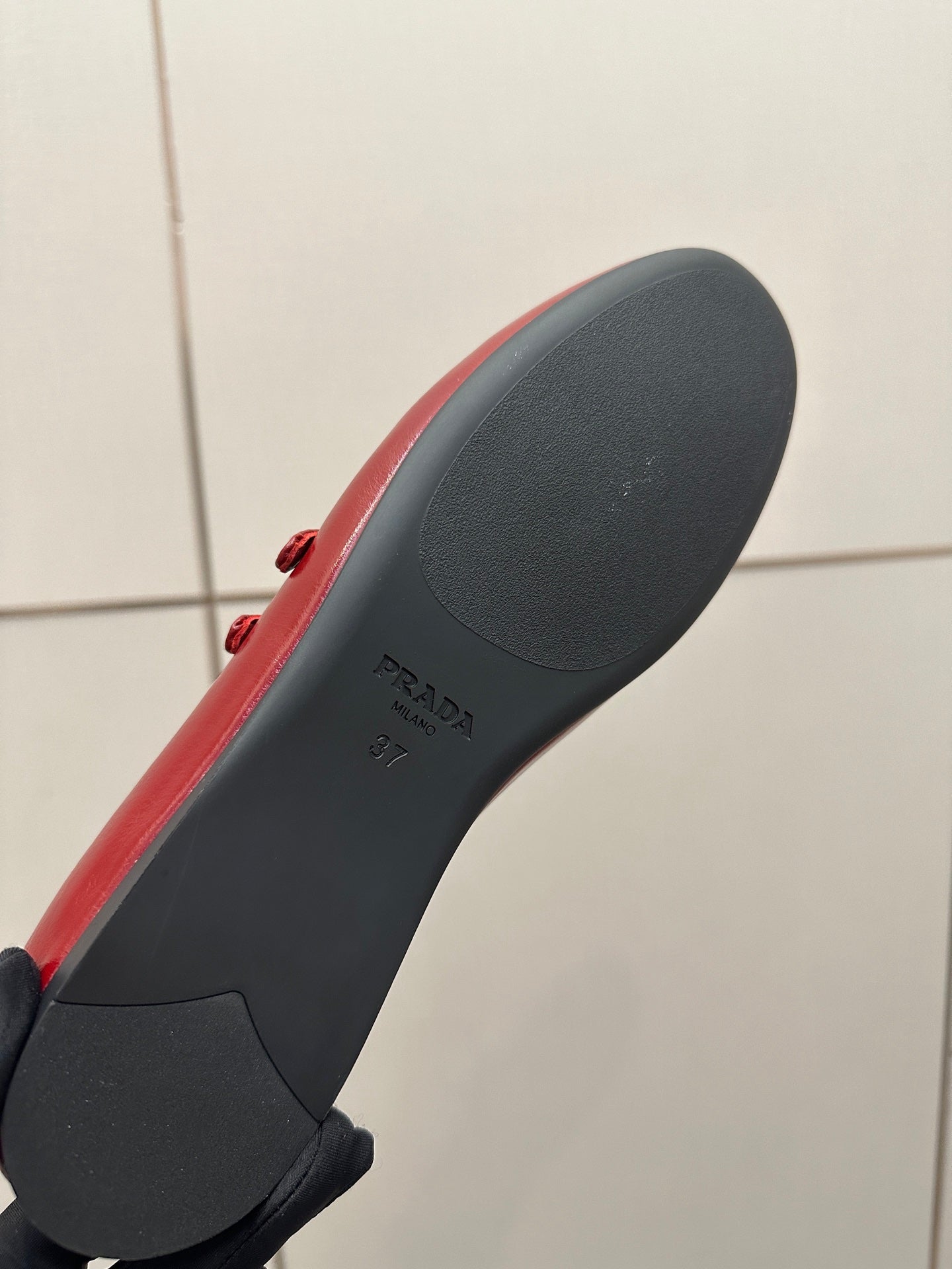 Prada women’s red leather loafer outsole with embossed logo and tread edge