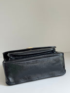 YSL bag with structured dark leather body and top flap