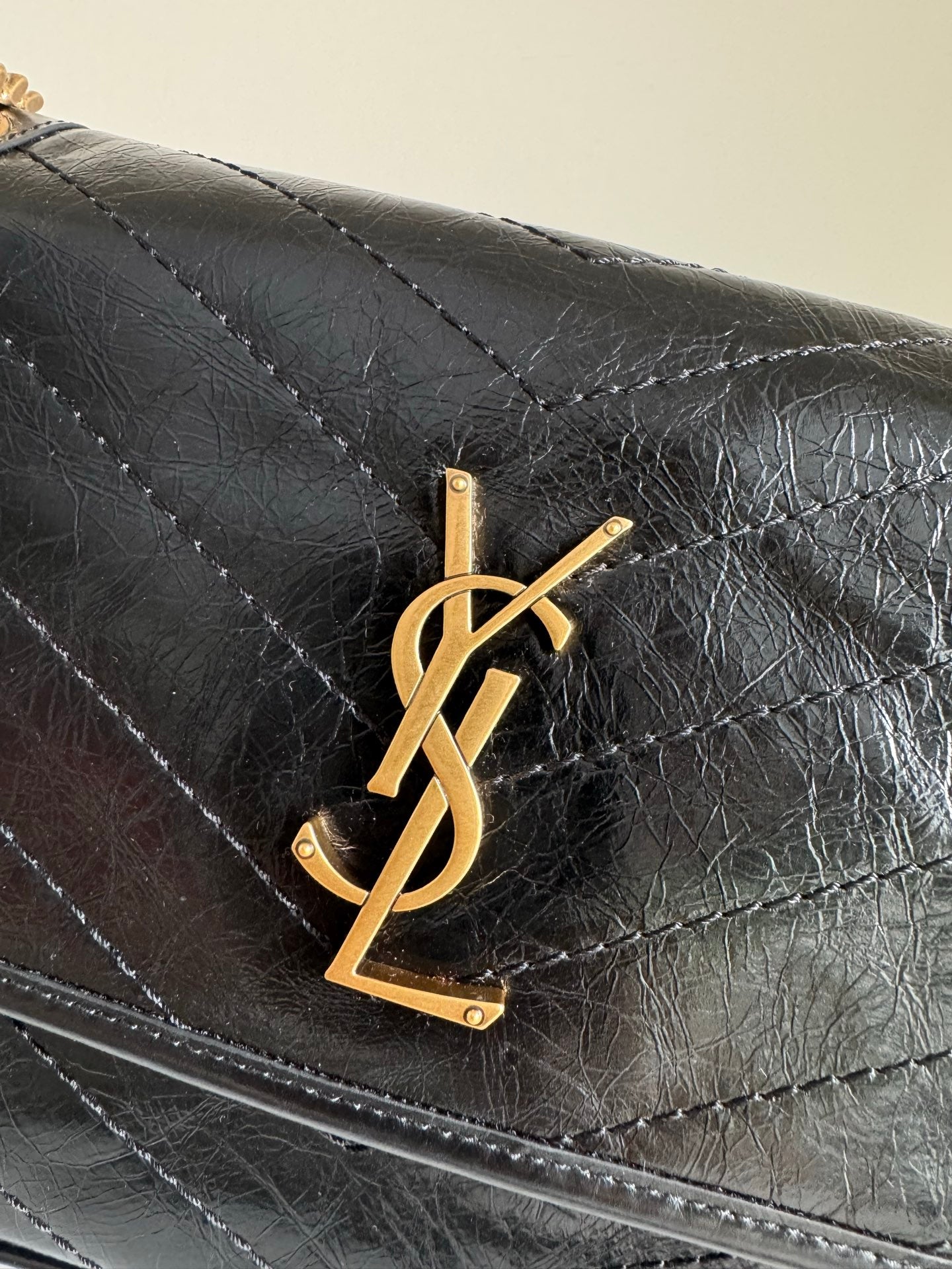 YSL quilted leather flap with gold YSL monogram on the front