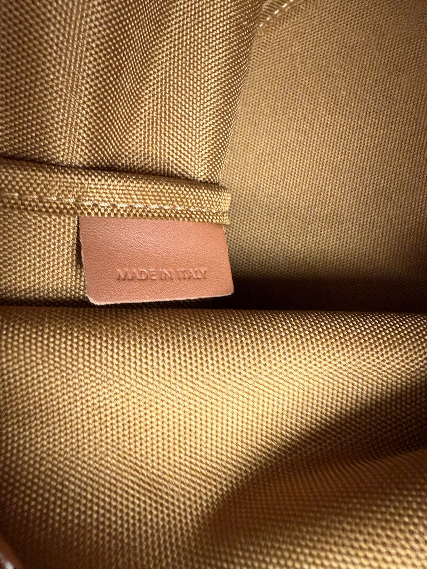 MiuMiu bag, tan leather brand patch tag on textured fabric panel
