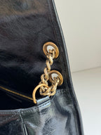 YSL bag close-up of gold Saint Laurent Paris clasp and chain link