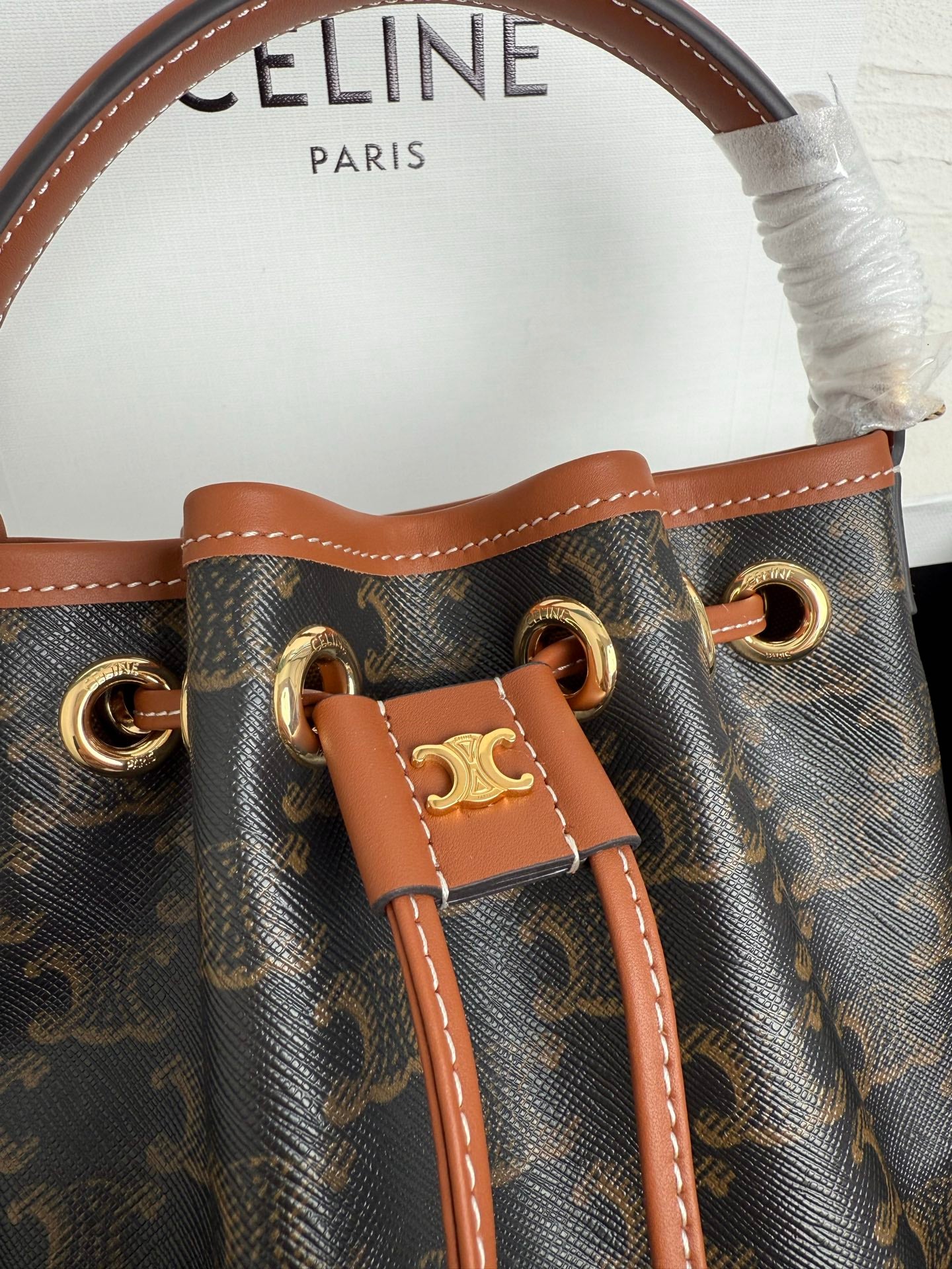 MiuMiu bag, monogram canvas with tan leather drawcord and gold-tone hardware front