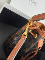 MiuMiu bag, monogram canvas bucket bag with tan strap, gold clasp and stitched seams