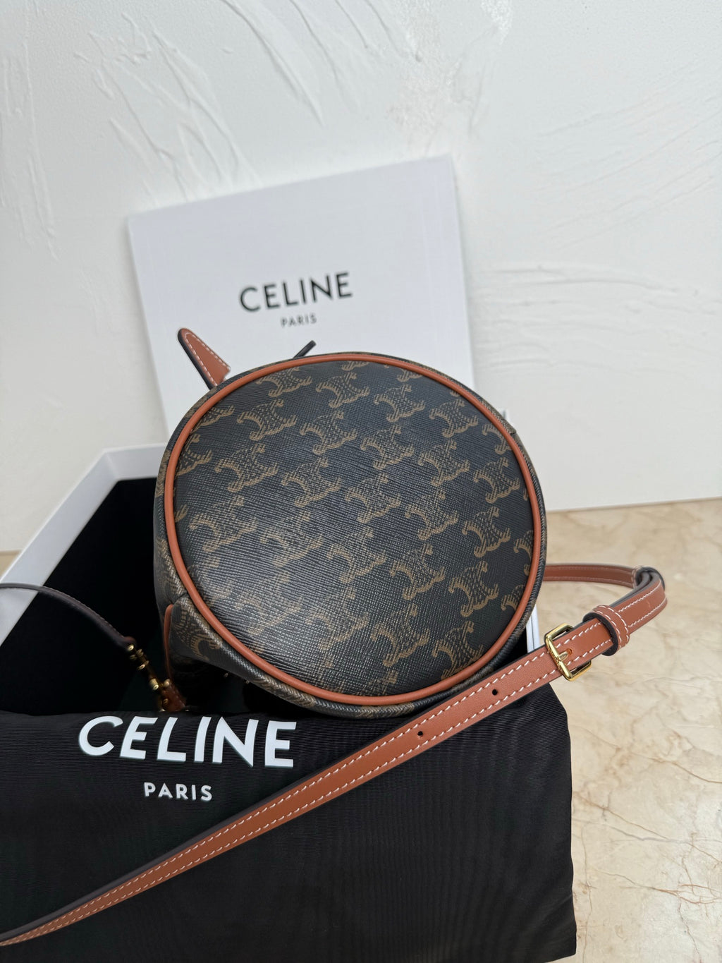 MiuMiu bag, round monogram pouch with tan leather trim and long shoulder strap