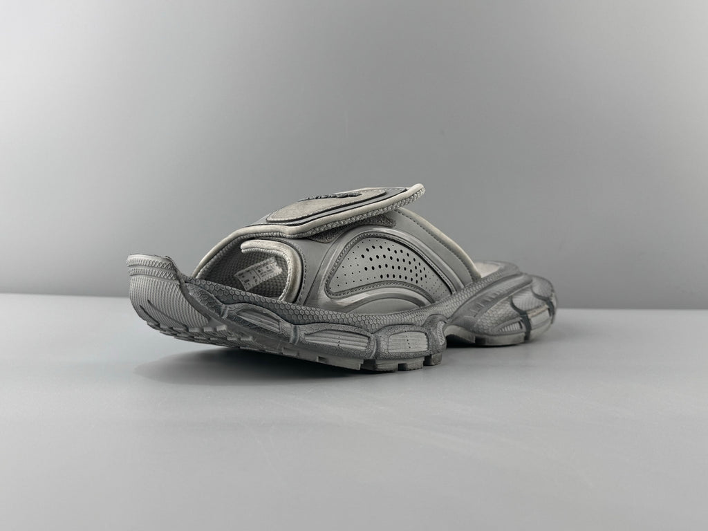 Light gray slide sandals with perforated upper and ribbed chunky sole