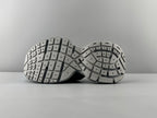 Pair of light gray sandals showing underside with patterned tread