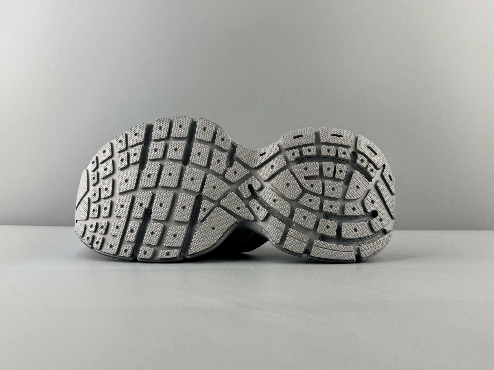 Pair of light gray sandals showing underside with patterned tread