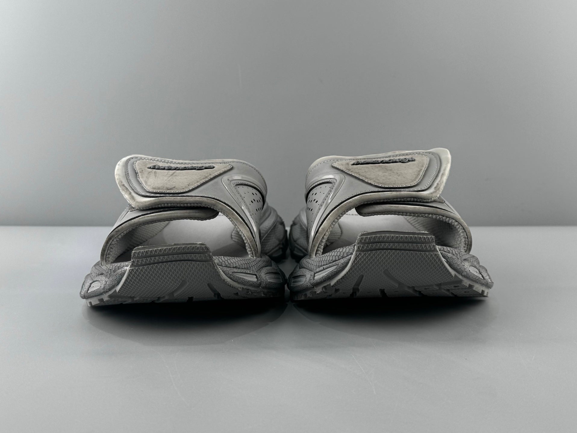 Pair of light gray sandals with adjustable straps and cushioned footbed