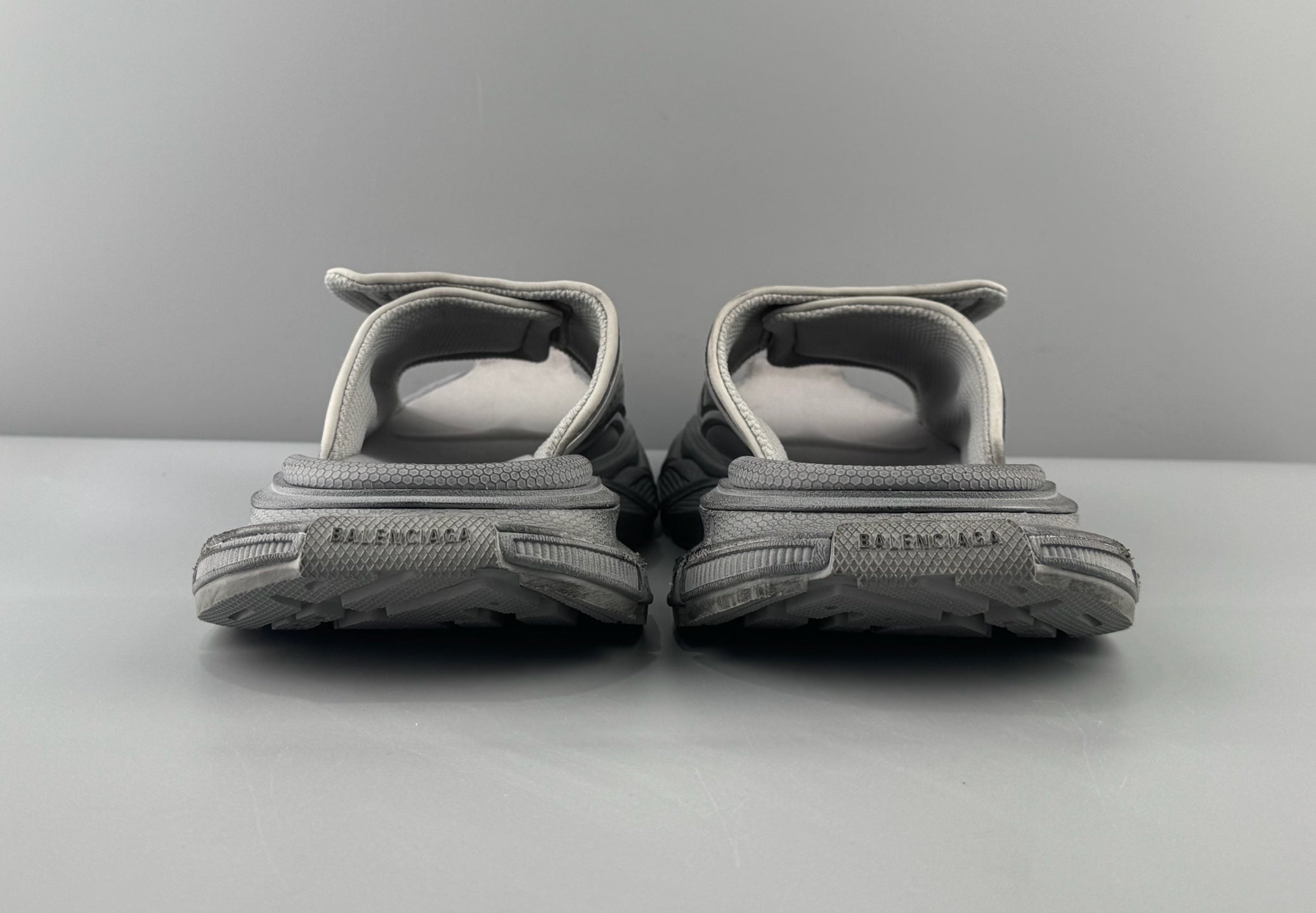 Pair of light gray sandals rear view with padded heel straps